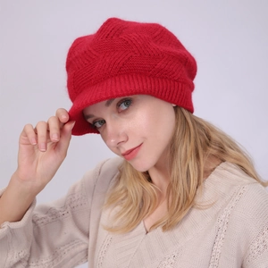Close-up of red twill knit newsboy hat with warm fuzzy lining and thick woven texture