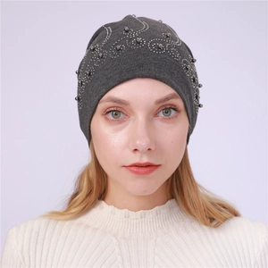 Close-up of elegant silver beads and rhinestones on a dark grey cotton slouchy beanie