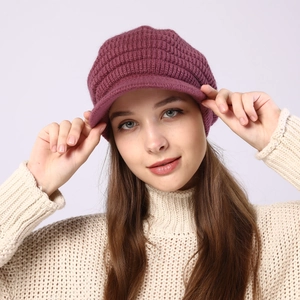 Close-up of pink striped knit visor beanie with warm fleece lining and thick wool texture