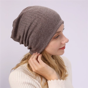 Detail of a brown slouchy beanie featuring sparkling silver rhinestones for winter fashion