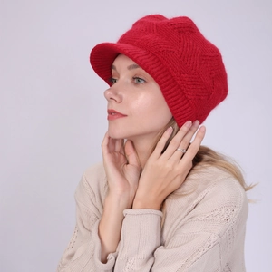 Detail of red twill knit peaked beanie showing soft texture and warm faux fur finish