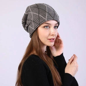 Close-up of grey knitted beanie with 3D diamond pattern on a long-haired model