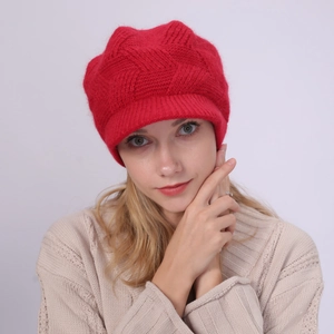 Side view of a bright red thick knit visor beanie for women on a model during winter