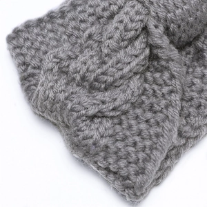 Macro shot of grey cable-knit headband detail showing premium wool texture and twist
