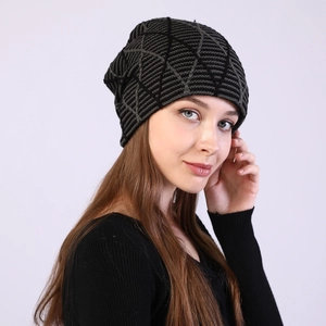 Macro view showing the geometric diamond pattern and ribbed texture of the knit beanie