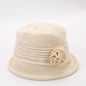 Detail of cream white knitted bucket hat with thick wool flower and rolled edge design