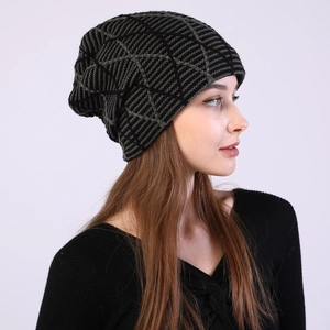 Detail view of the geometric knit pattern on a gray and black winter fleece beanie