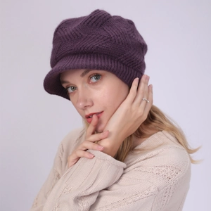 Detailed knit texture of deep purple winter peaked beanie hat with warm ear protection