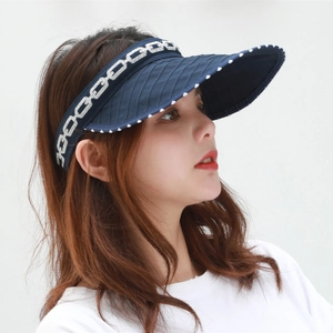 Women's dark blue sun visor with white polka dot trim and silver chain pattern