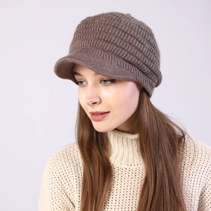 Detailed knit texture and stiff brim of women's warm brown striped baker boy cap