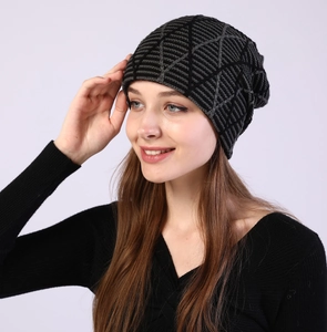Detail of grey and black geometric knit beanie with warm fleece lining for winter wear