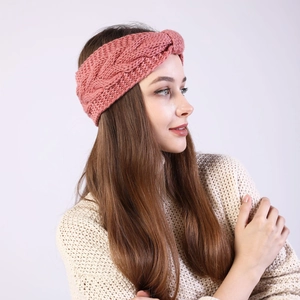 Close-up of pink cable knit headband showing thick twist pattern and soft texture
