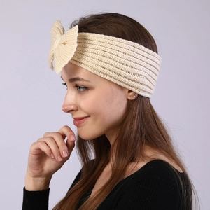 Detailed knit texture of beige bow headband showing soft yarn for winter hair accessory