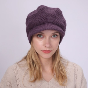 Detailed close-up of dark purple knit cap with visor featuring 3D geometric texture