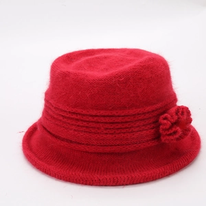 Close-up of red knitted winter bucket hat featuring soft faux rabbit fur and floral detail