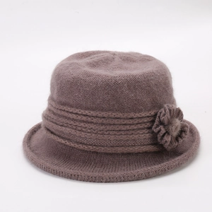 Detailed close-up of a warm purple knitted flower pot hat with soft faux rabbit fur texture