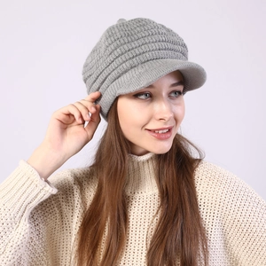Detail of light grey striped knitted newsboy hat showing soft texture and brim