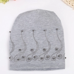 Detail of grey cotton beanie featuring elegant pearl and rhinestone floral wave patterns