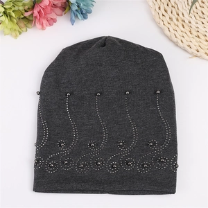 Detailed view of dark grey cotton beanie with elegant pearl wave patterns and floral accents
