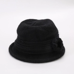 Detail of black winter knit bucket hat with a stylish floral accent for women