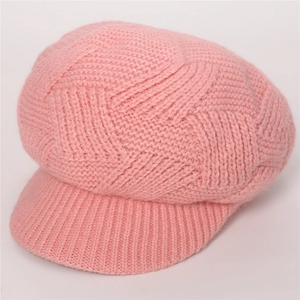 Close-up of pink cable-knit beanie with soft visor showing warm fuzzy texture