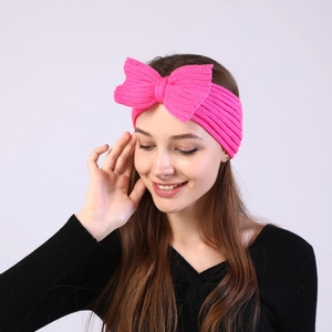 Close-up of hot pink rib knit headband with a large bow showing soft texture and elasticity