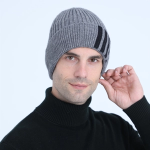 Detail of grey ribbed knit beanie with three black stripes and thick wool lining