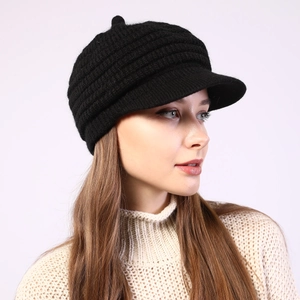 Close-up of black striped knit beret with visor showing thick texture and top button
