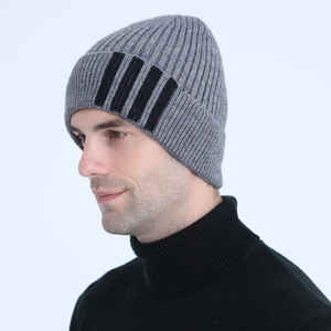 Detail view of men's grey knit beanie featuring four black vertical stripes on soft wool fabric