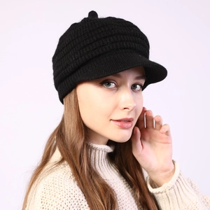Close-up of black striped knit peak cap showing thick texture and warm winter material