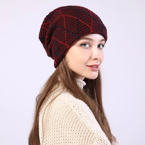 Close-up of diamond pattern knit beanie in navy and burgundy yarn for winter warmth