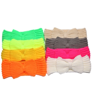 Close-up of knit bow headbands in vibrant colors like neon green, yellow, and peach