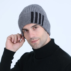 Detailed texture of grey ribbed knit beanie featuring three black vertical stripes for warmth