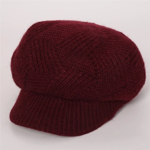 Macro shot of dark red twill knit texture and ribbed edge of the warm winter baker boy hat
