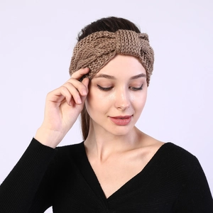 Close-up of camel knit headband with cable twist texture and thick wool fabric