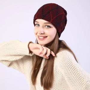 Close-up of red and navy geometric knit beanie featuring a warm fleece-lined texture