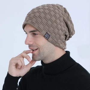 Detail shot of men's winter beanie with thick knit texture and small bear logo label