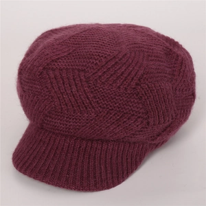 Detail of deep purple knit peak cap featuring geometric diamond pattern and fuzzy texture