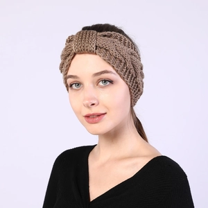 Detailed view of brown chunky cable knit texture on a warm winter headband