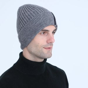 Detail view of the deep grey rib-knit beanie showing the textured weave and side trim
