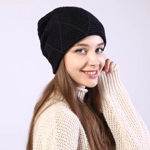 Close-up of black knitted beanie showing diamond pattern weave and thick thermal texture