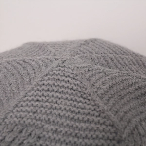 Detailed macro view of the grey twill knit texture and plush fleece lining on the winter hat