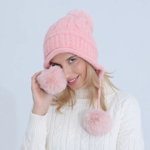 Dettaglio del cappello in maglia di ciniglia rosa con pompon e fodera in pile calda