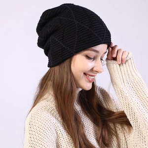 Detail view of the black knit beanie with textured geometric diamond knit pattern