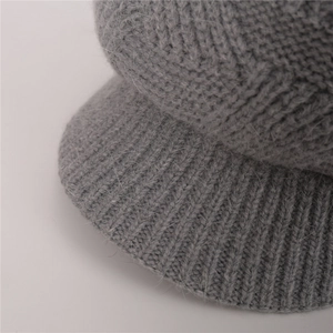 Close-up of grey twill knit beanie with plush rabbit fur texture and short brim detail