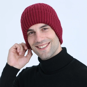 Detail of burgundy ribbed knit beanie showing thick texture and warm fleece lining for men