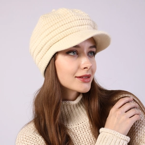 Detailed close-up of cream knit visor beanie showing soft thick ribbed texture