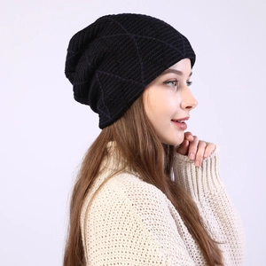 Detailed side view of a black knit beanie with rhombus pattern on a male model