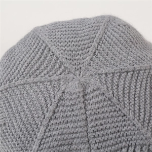 Detailed top view of grey knit beanie featuring star-shaped stitching and fuzzy texture