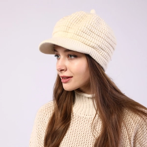 Detail view of cream knit peaked beanie with thick ribbed texture for women